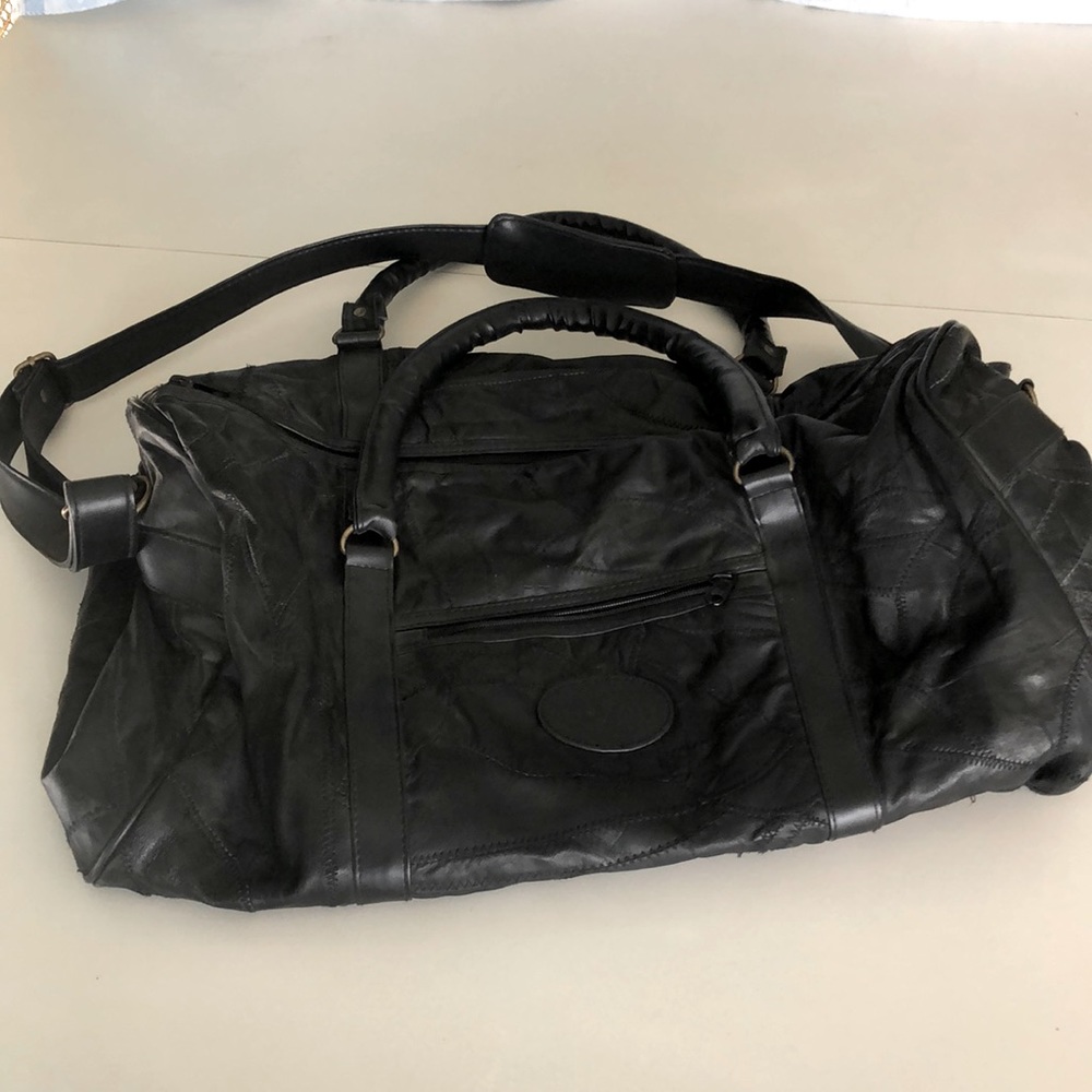 Unisex black patch leather carry on duffel bag.
